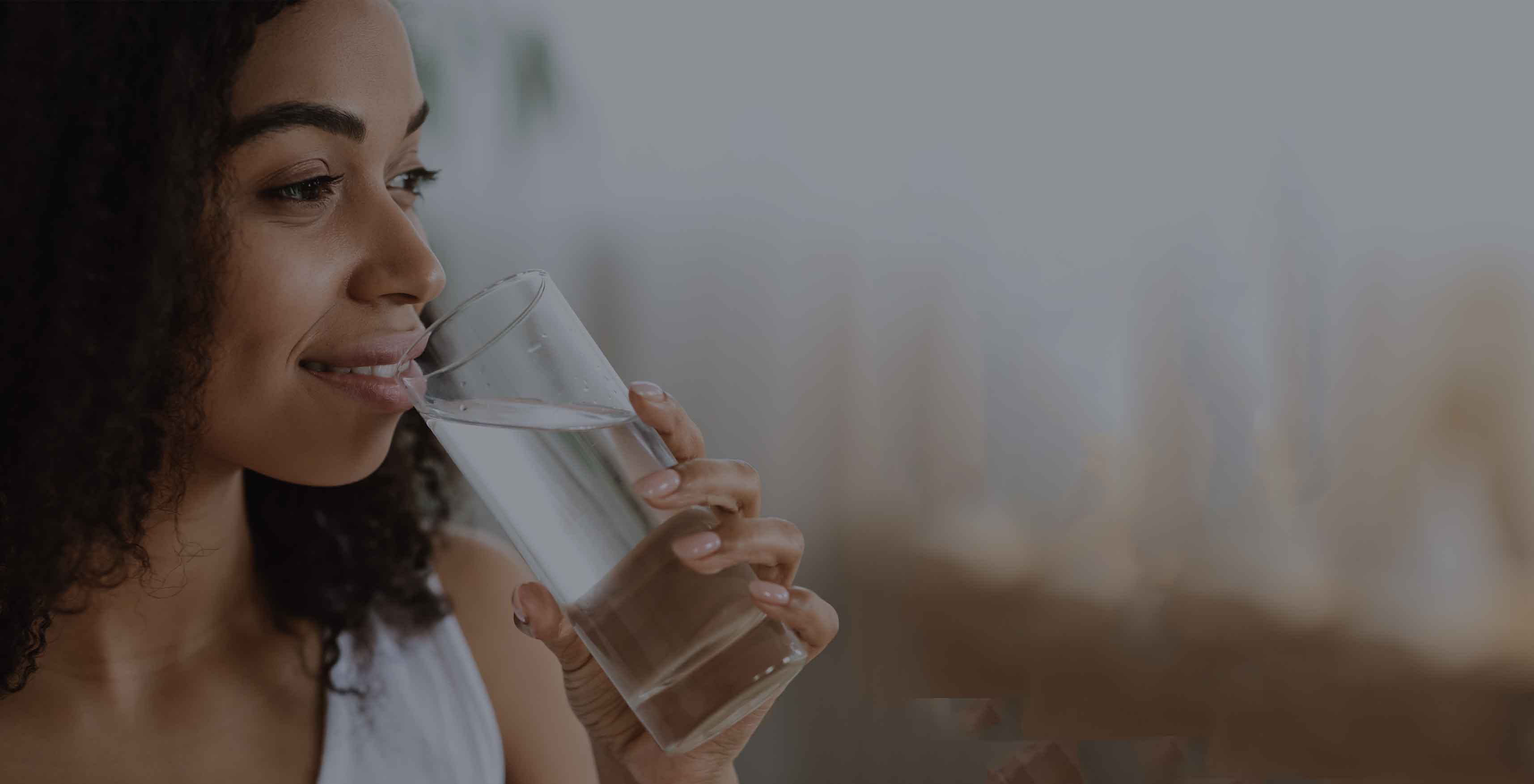 lady drinking still water in glass