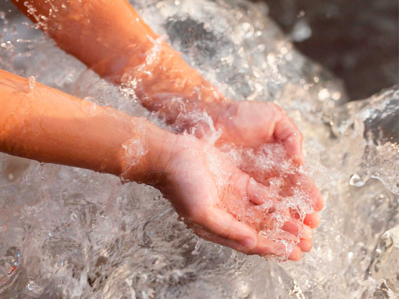 hands holding drinking water