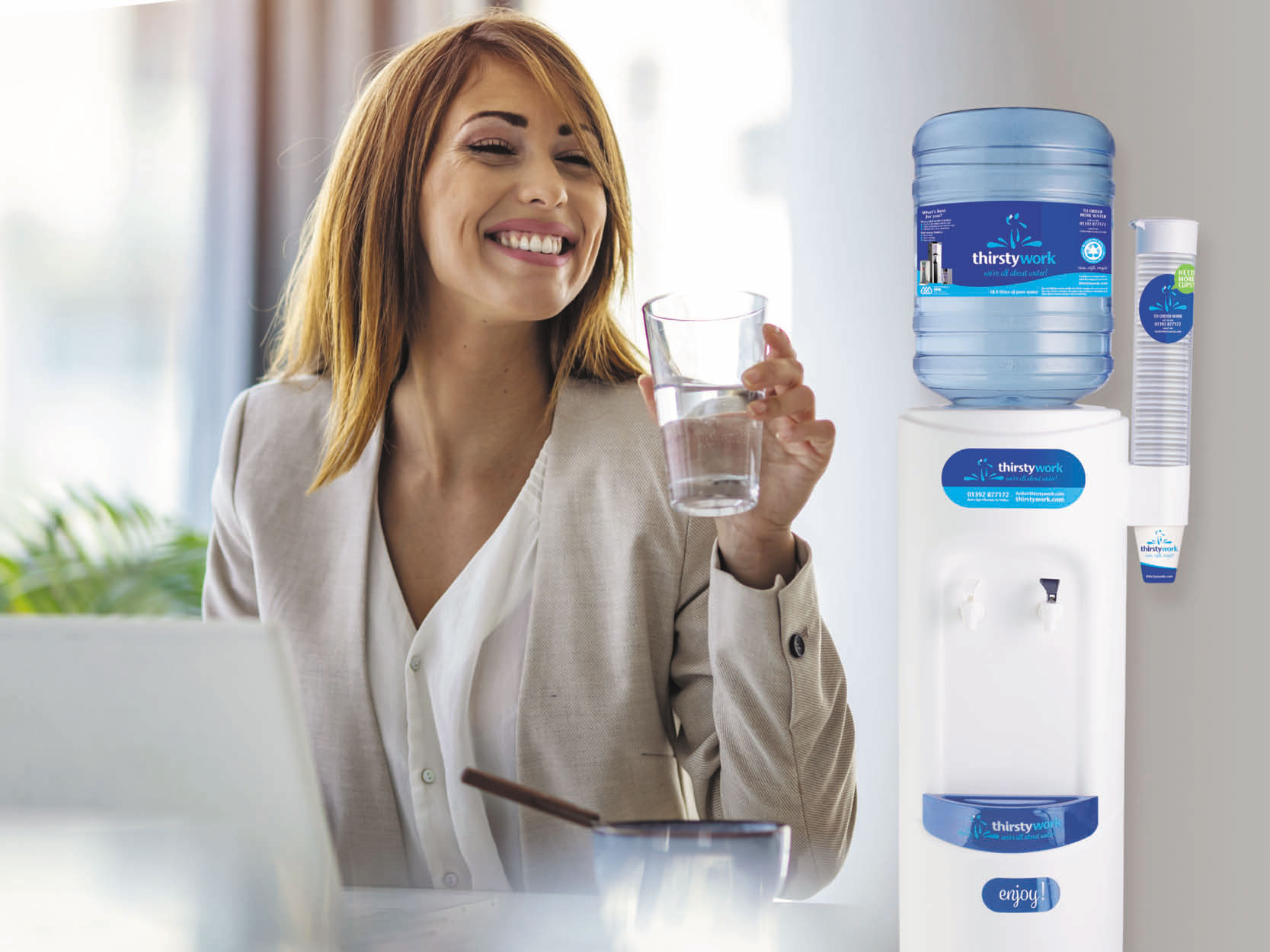 office worker drinking water from a bottled water cooler rental