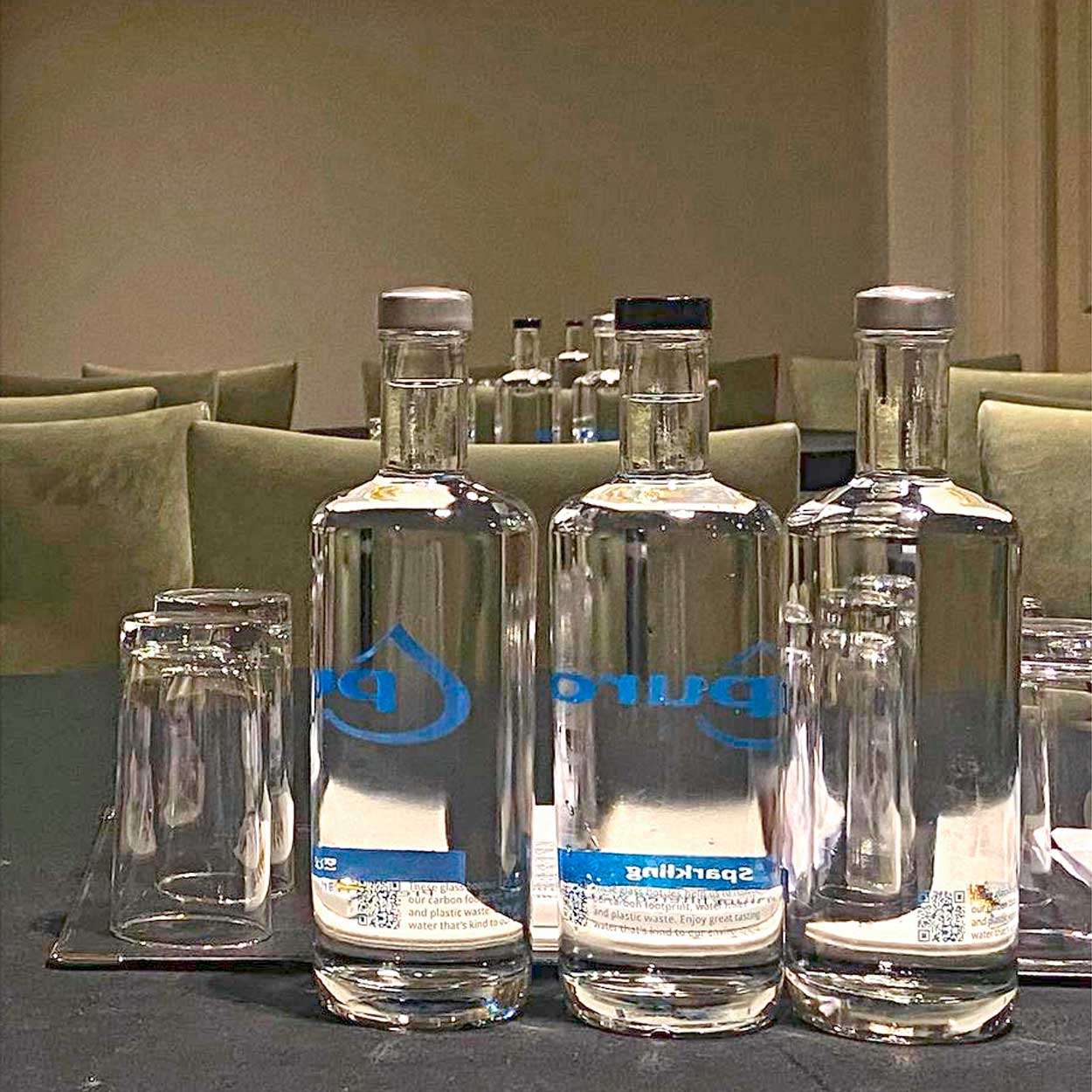 Pura glass water bottles on meeting room table