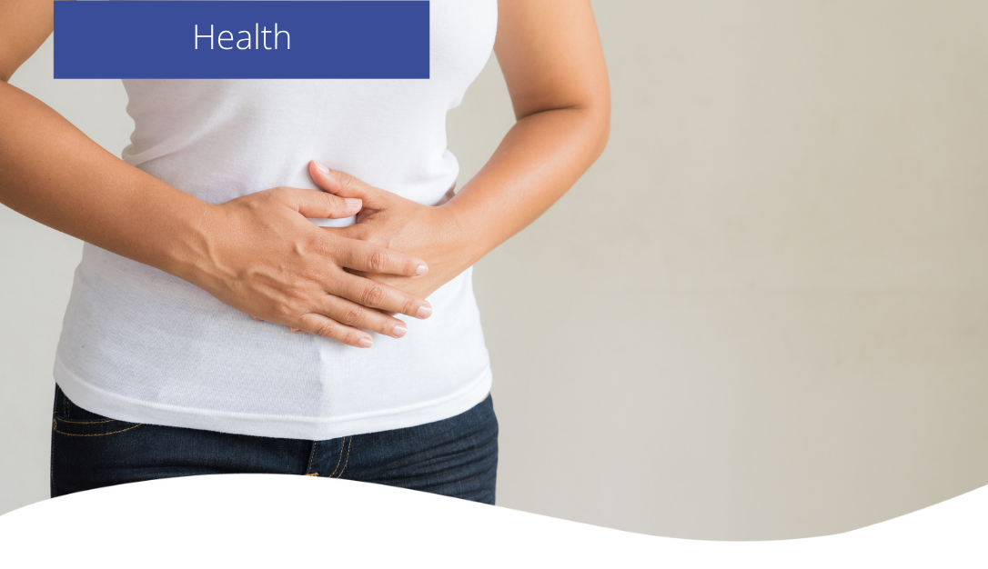 A woman holding her stomach due to being bloated